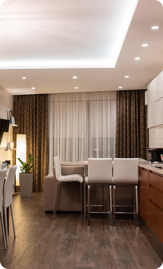 Finished basement kitchen island and dining area with recessed lighting