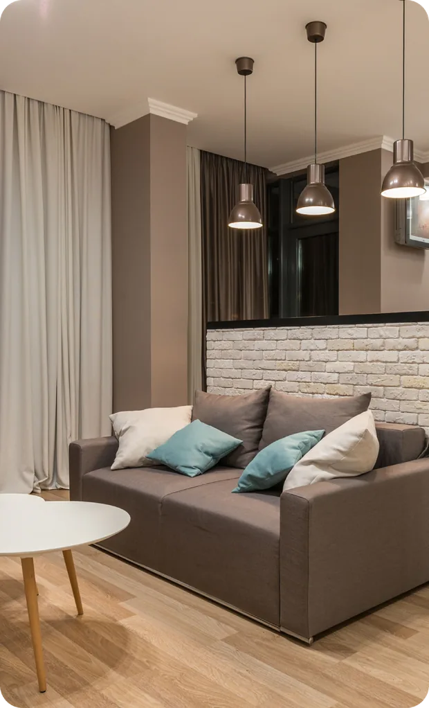 Finished basement living area with sectional sofa and pendant lights in Mason, Ohio