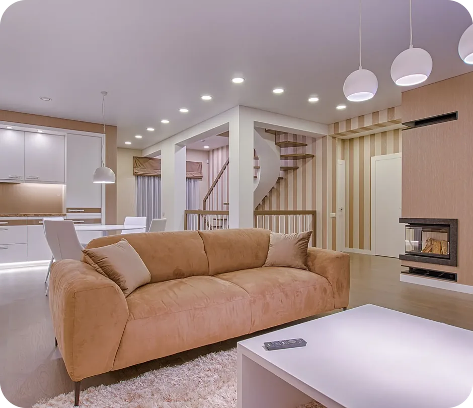Finished basement living area with sofa, kitchen, fireplace and staircase in Mason, Ohio