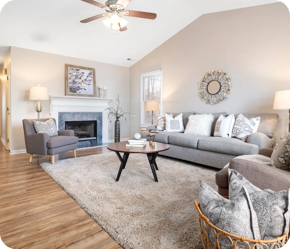 Finished basement living room with fireplace, sofa and armchairs in Mason, Ohio