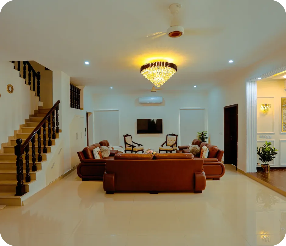 Finished basement living room with leather sectional, armchairs and staircase