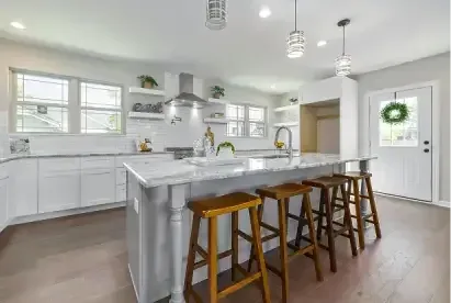 Remodeled white kitchen with island and wood bar stools